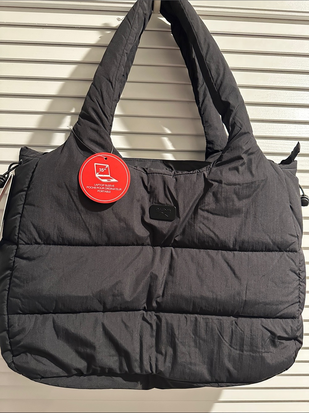NWT Reebok Puffer Laptop Shoulder Bag w/ outside back pocket and Zipper closure.